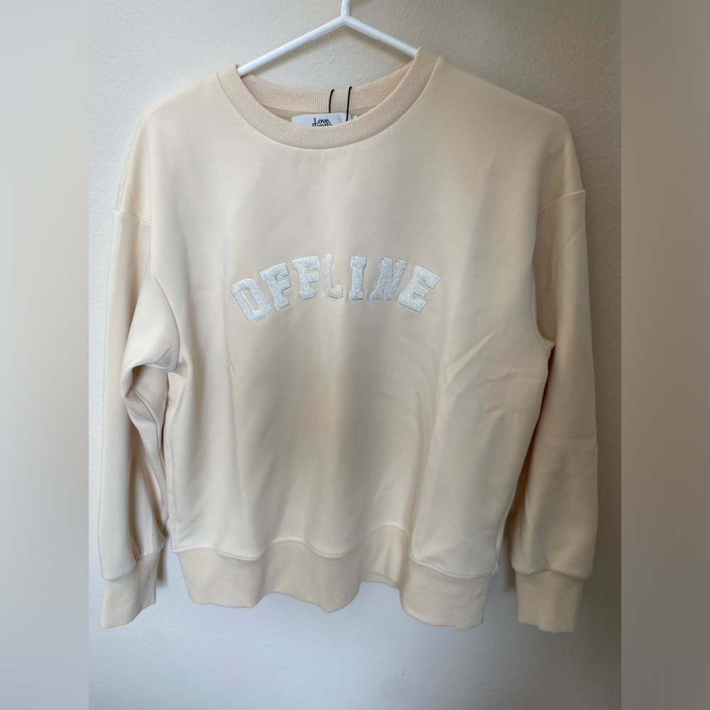 Love Bonito, cream sweatshirt that says “OFFLINE”